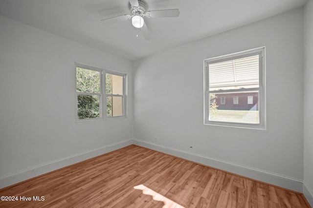 unfurnished room featuring light wood-type flooring and ceiling fan