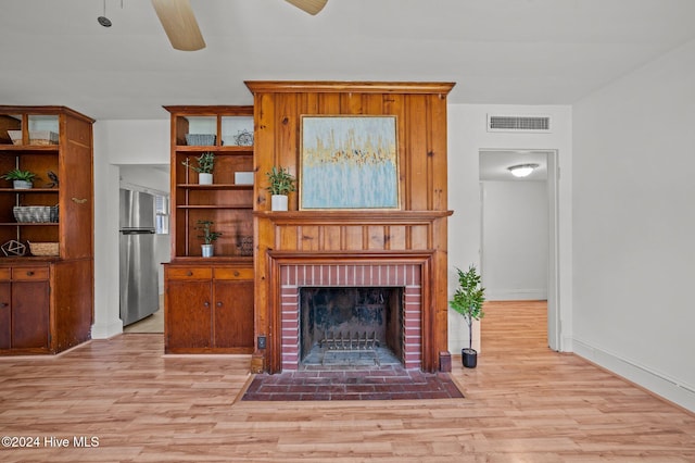 living room with a fireplace and light hardwood / wood-style flooring