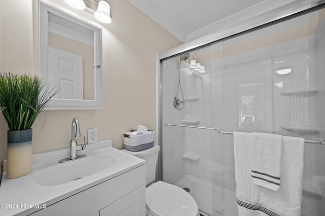 bathroom featuring crown molding, toilet, an enclosed shower, and vanity