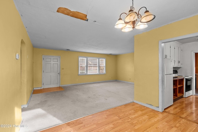 interior space with light wood-type flooring and an inviting chandelier