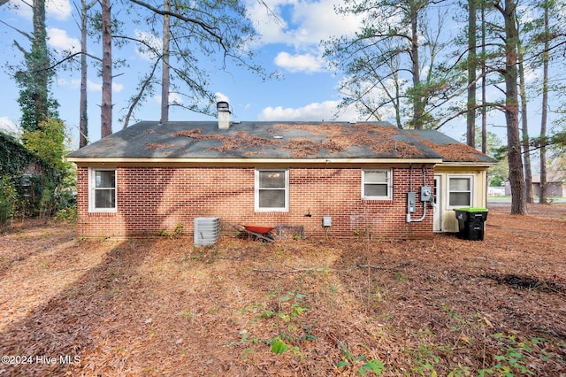 rear view of house with central air condition unit