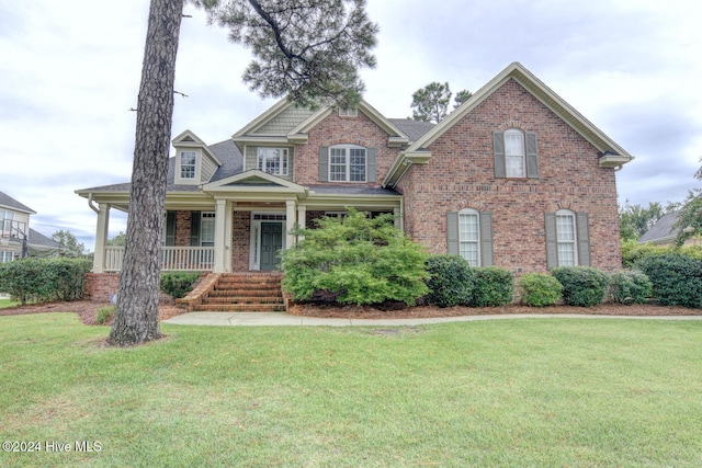 view of front of home featuring covered porch and a front yard