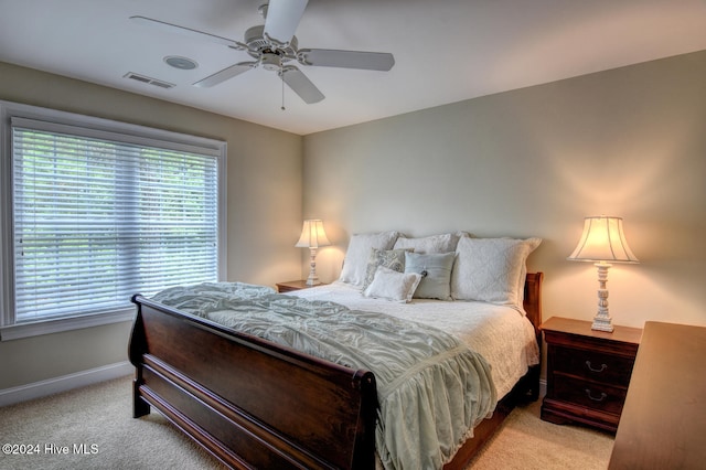 bedroom featuring ceiling fan and light carpet