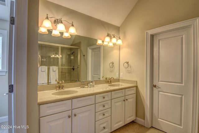 bathroom featuring vanity, vaulted ceiling, and a shower with door