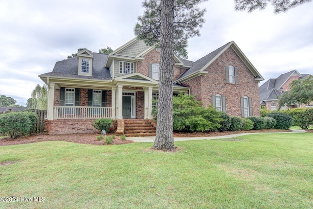 view of front of property with a porch and a front yard