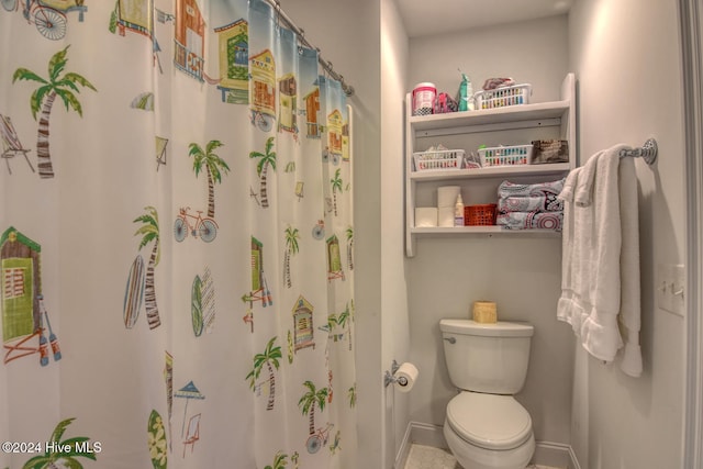 bathroom with a shower with curtain and toilet