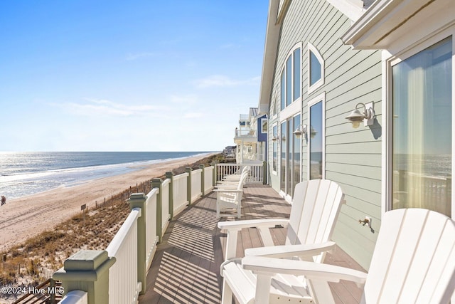 balcony with a beach view and a water view