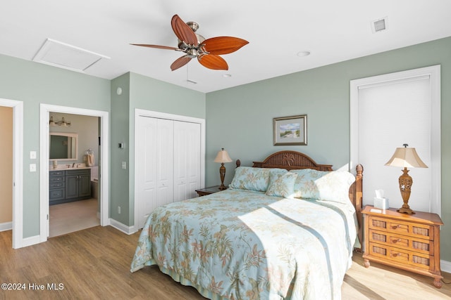 bedroom featuring ceiling fan, ensuite bathroom, light hardwood / wood-style floors, and a closet