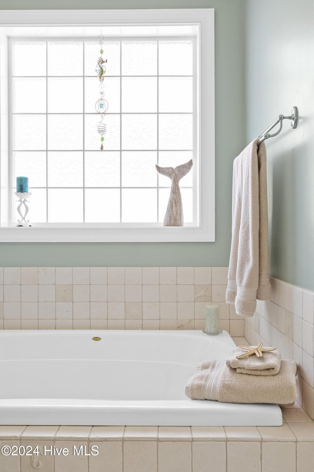 bathroom featuring tiled tub