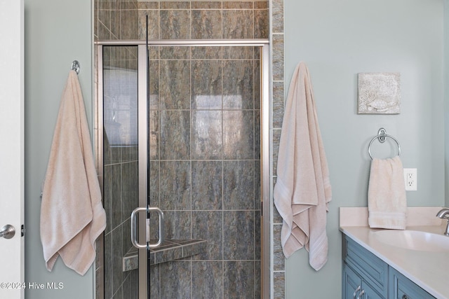 bathroom with walk in shower and vanity