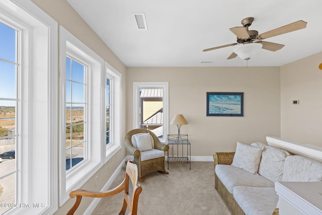 living room featuring light carpet and ceiling fan