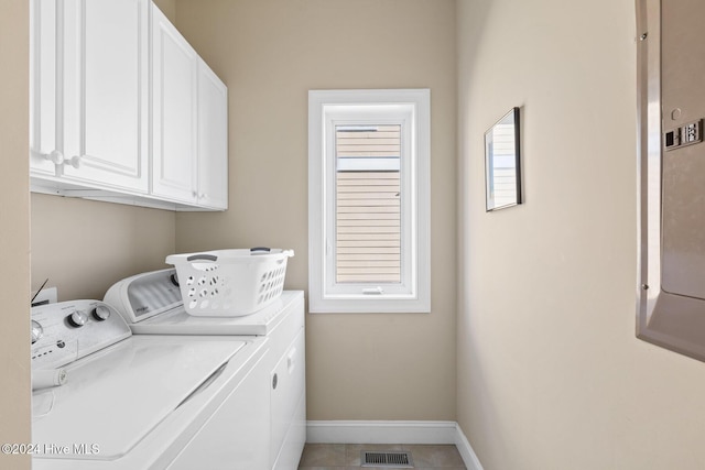 laundry area with washing machine and dryer and cabinets