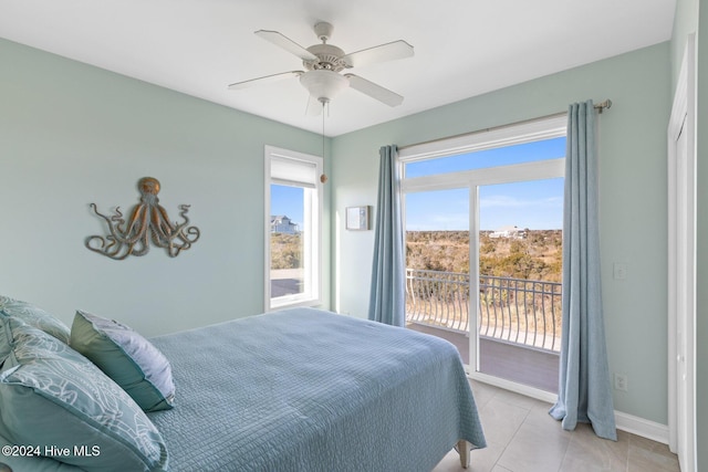 tiled bedroom with access to exterior and ceiling fan