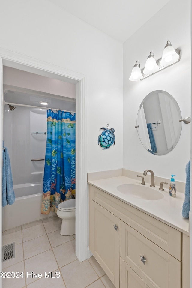 full bathroom featuring shower / bath combination with curtain, tile patterned floors, toilet, and vanity