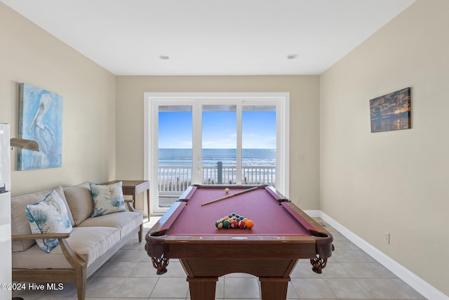 recreation room with a water view, billiards, and light tile patterned floors