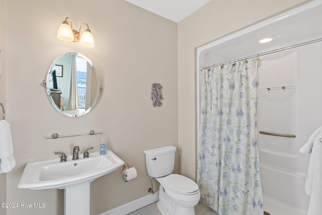 bathroom with walk in shower, sink, toilet, and tile patterned flooring