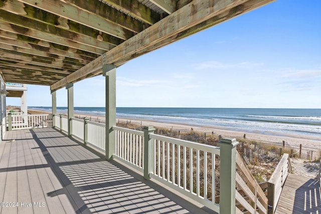 deck with a beach view and a water view