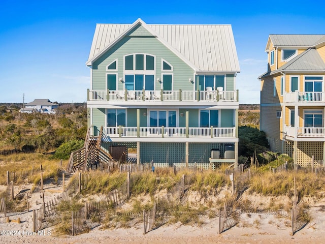 rear view of property with a balcony