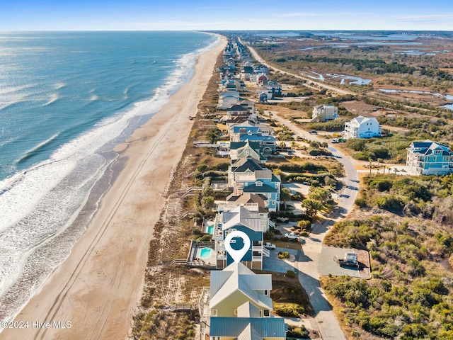 bird's eye view featuring a water view and a beach view