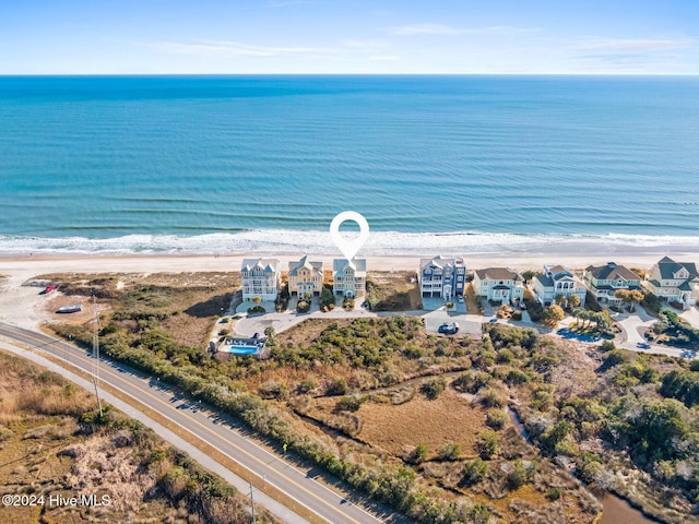 bird's eye view featuring a water view and a view of the beach