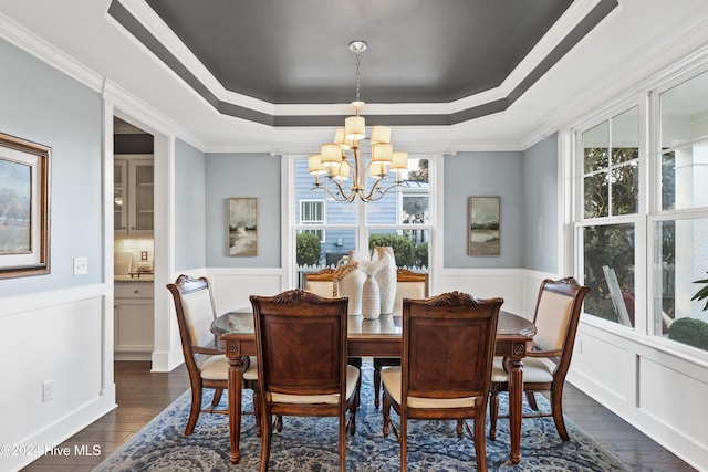 dining area with a notable chandelier, crown molding, dark wood-type flooring, and a wealth of natural light