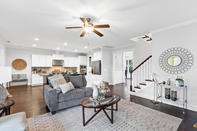 living room featuring crown molding, dark hardwood / wood-style flooring, ceiling fan, and sink