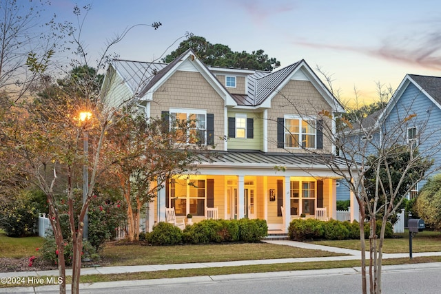 view of front of home featuring a lawn and a porch