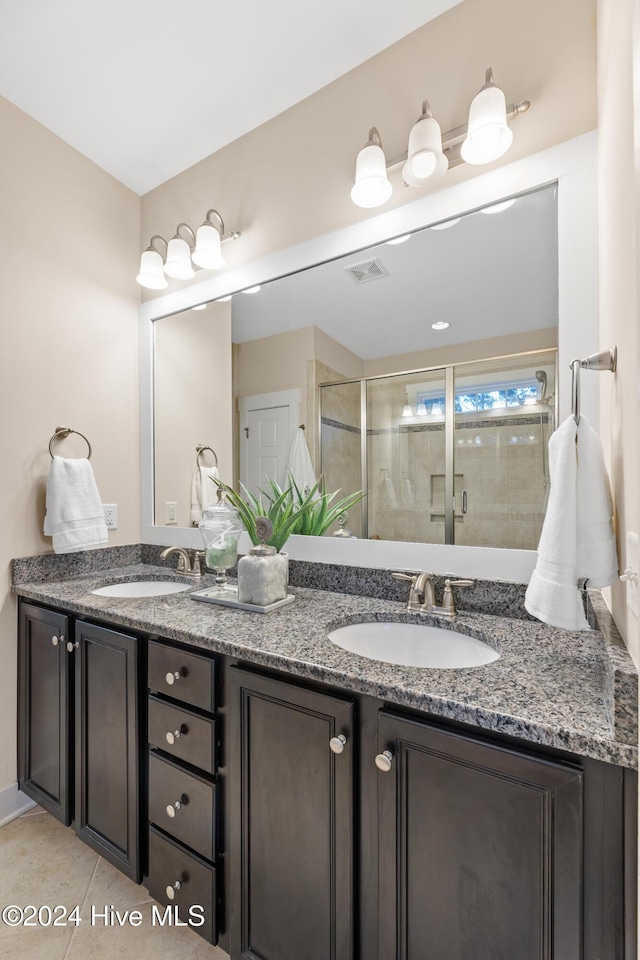 bathroom featuring tile patterned flooring, vanity, and walk in shower