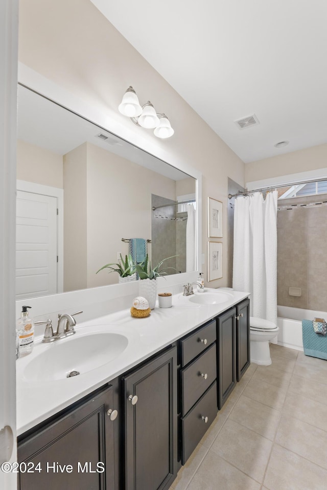 full bathroom with tile patterned floors, vanity, shower / tub combo, and toilet