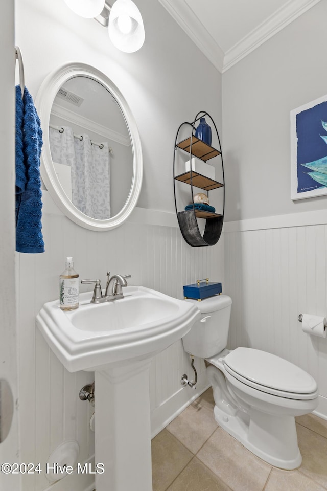 bathroom featuring tile patterned floors, sink, toilet, and crown molding