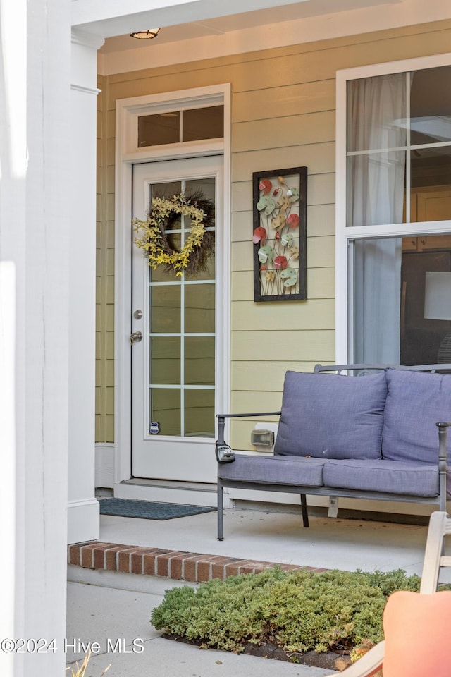 view of exterior entry featuring covered porch