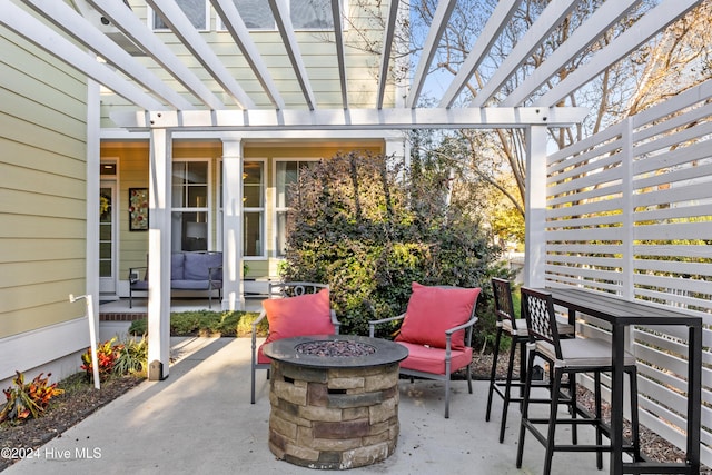 view of patio featuring a pergola and a fire pit