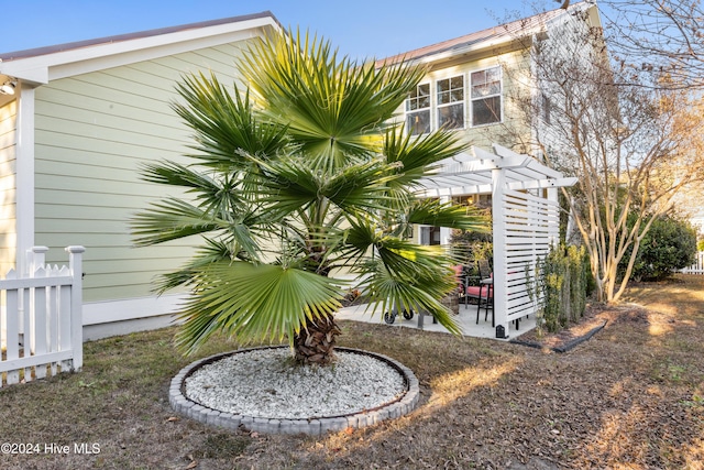 view of side of property featuring a pergola and a patio area