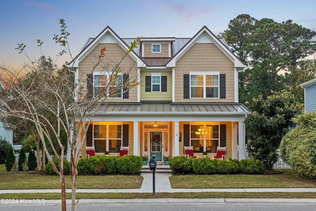 craftsman house featuring a lawn and covered porch