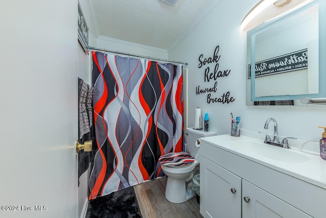 bathroom featuring ornamental molding, vanity, a textured ceiling, hardwood / wood-style flooring, and toilet