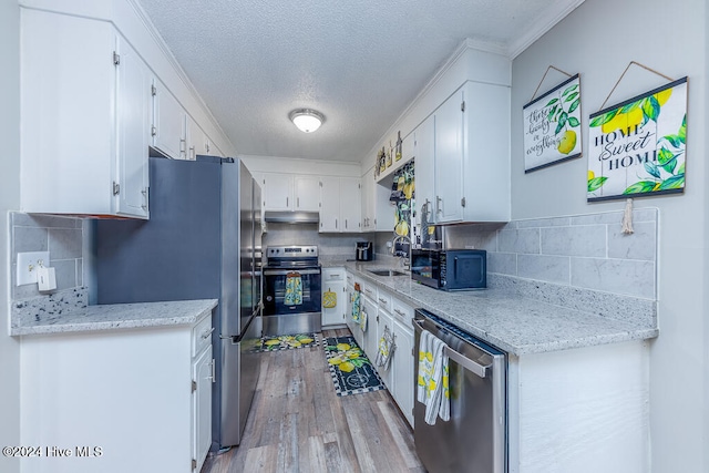 kitchen featuring white cabinetry, light hardwood / wood-style flooring, stainless steel appliances, and sink