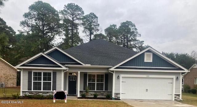 craftsman-style home with a front yard and a garage