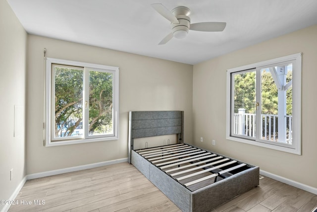 bedroom with ceiling fan and light wood-type flooring