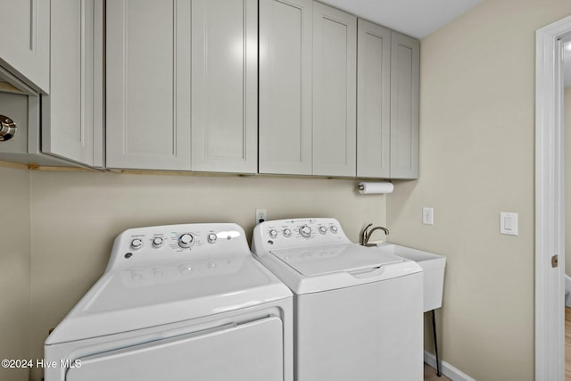 washroom with cabinets and separate washer and dryer