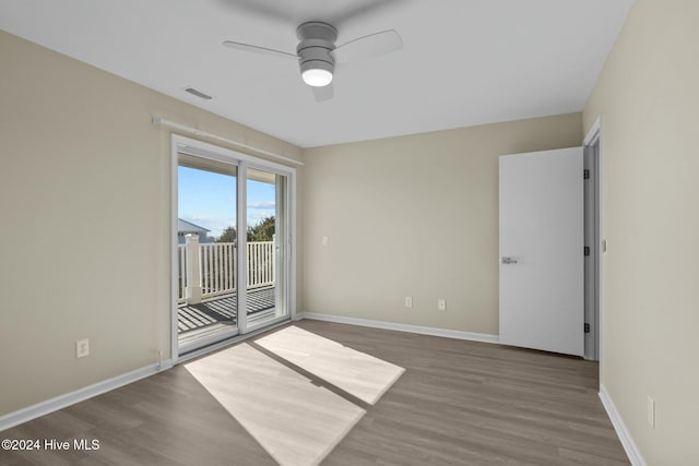 empty room with hardwood / wood-style flooring and ceiling fan