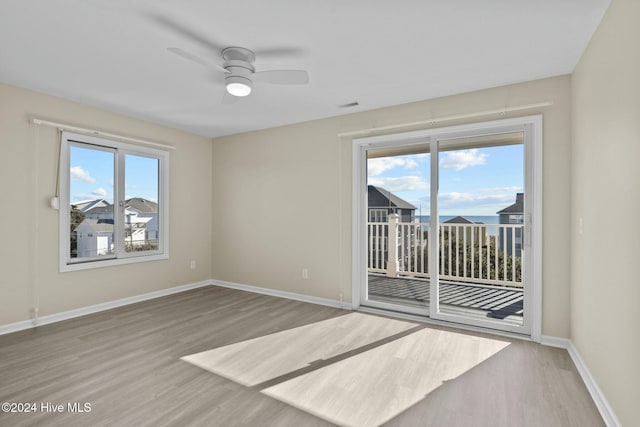 unfurnished room featuring ceiling fan and hardwood / wood-style flooring