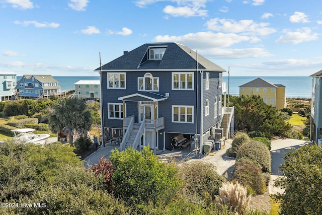 rear view of property featuring a carport and a water view