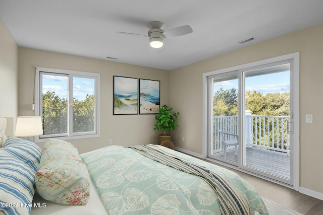 bedroom featuring access to exterior, light hardwood / wood-style floors, and ceiling fan