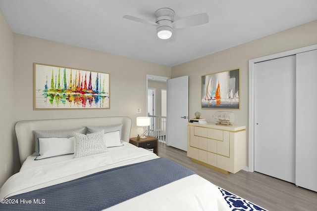 bedroom with a closet, ceiling fan, and hardwood / wood-style floors