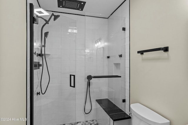 bathroom featuring toilet and walk in shower