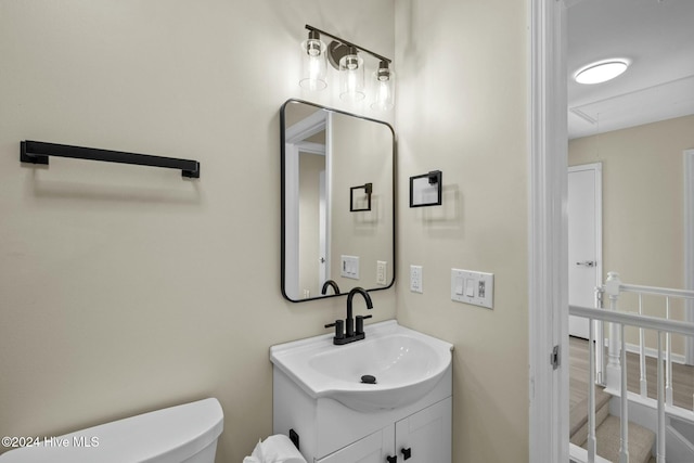 bathroom featuring vanity and toilet