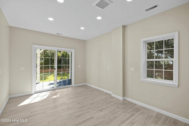 bathroom with hardwood / wood-style flooring, vanity, toilet, and a shower with shower door