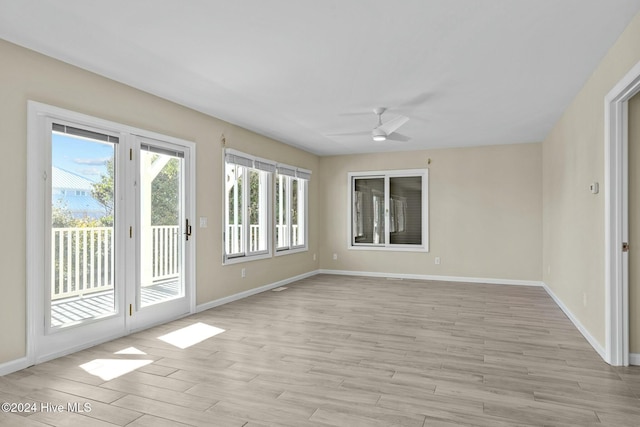 empty room featuring ceiling fan and light wood-type flooring