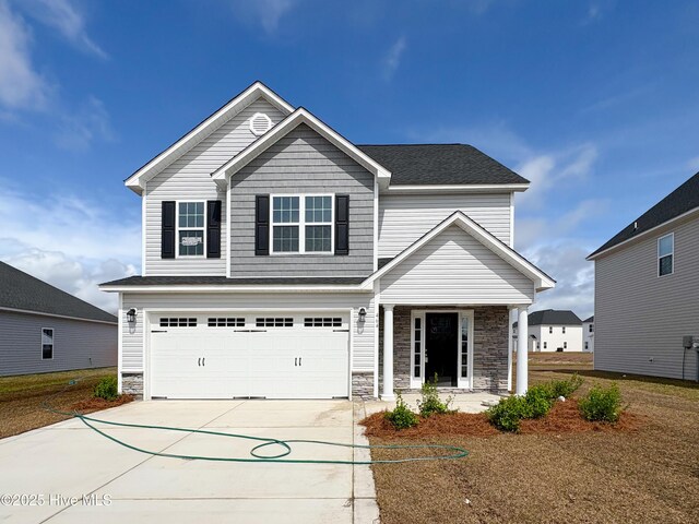 view of property featuring a garage, a front yard, central air condition unit, and a porch