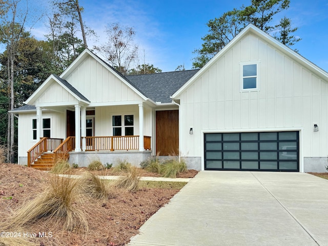 modern inspired farmhouse featuring a porch and a garage